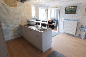 a kitchen with a sink and a counter top at Ferienhaus Schnitterkarten - nur an Feriengäste - ABC366 in Klütz +14 photos