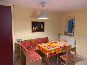 a dining room with a table and a table and chairs at Ferienwohnung mit Garten und Ostseenähe OVS 111 in Rakow +13 photos