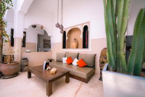 a living room with a couch and a table at Riad Dar Massai in Marrakesh