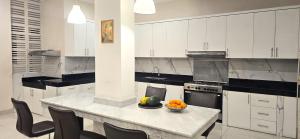 a kitchen with a table with a bowl of fruit on it at Ease Living Palem Kenari in Jatirarangan