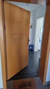 a large wooden door in a room with a hallway at Uhlenhuus - Schöller GM 69765 in Graal +22 photos
