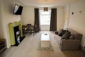 a living room with a couch and a table at Spacious 3 Bedroom Home on South Shields Coast in Westoe