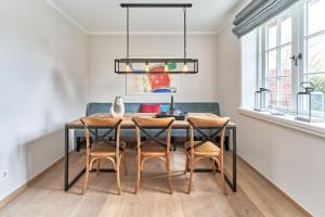 una sala da pranzo con tavolo e sedie di Ferienhaus Silbermöwe 7d a List