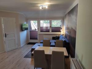 a living room with a couch and a table at Gästehaus Harzklause 6 in Sieber