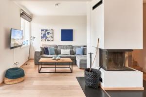 un soggiorno con divano e camino di Ferienhaus Silbermöwe 7b a List Altre 35 foto