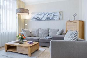 a living room with a couch and a coffee table at Appartements Villa Glückspilz OFC 27 in Kühlungsborn
