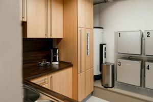 a kitchen with wooden cabinets and a sink at C99 Frank in Cologne