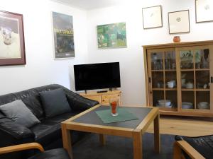 a living room with a couch and a coffee table at Appartement "Deichblick" - Nordseebad Burhave in Burhave