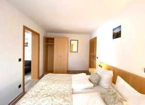 a bedroom with a large bed and a closet at Süderhaus Hiddensee App 4 in Neuendorf