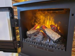 a grill with three pieces of meat in it at Luxury Holidays Yorkshire - Bancroft Cottage in Bedale