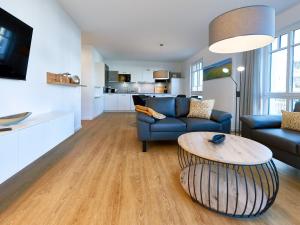 a living room with a couch and a table at Villa Beatrice - Wohnung 03 in Binz +27 photos