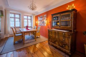 a dining room with a table and a wooden cabinet at Alte Seilerei in Görlitz