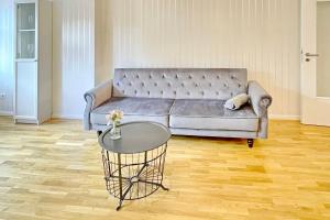 a living room with a couch and a table at Ferienwohnung Altstadtidyll in Lübbenau