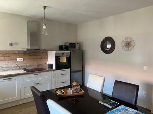 a kitchen with a table and a black refrigerator at Downtown Accommodation 2BR in Zadar