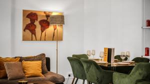 a dining room with a table and green chairs at Elegant Escape in Covent Garden in London