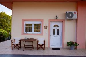 a patio with a table and chairs and a door at Fairy Dreams in Konitsa