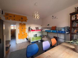 a room with two bunk beds and a table and chairs at Peacefull Rooms Bologna Collodi 9 in Bologna