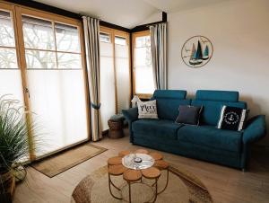 a living room with a blue couch and a table at Residenz Seestern Ws 08 in Kühlungsborn