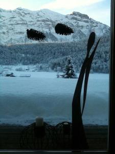 a window with a view of a snow covered mountain at Apartment Marialis in Bizau