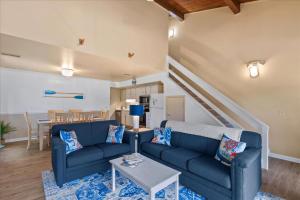 ein Wohnzimmer mit einem blauen Sofa und einem Tisch in der Unterkunft 32 Borderlinks in Ocean Pines + 32 Fotos