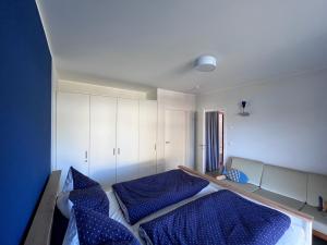 a bedroom with two beds with blue pillows at Ferienhaus kleiner Findling in Neu Gaarz