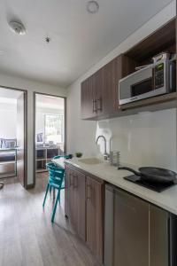 a kitchen with a sink and a microwave at Cozy and centrally located flat near Monserrate - 11009 in Bogotá