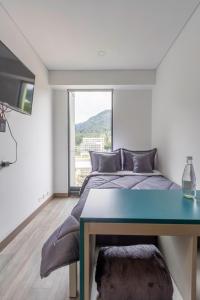 a bedroom with a bed and a large window at Cozy and centrally located flat near Monserrate - 11009 in Bogotá