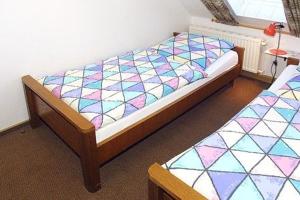 a bedroom with a bed and two twin beds at Landhaus Schwanenhof in Ostbense in Westbense +22 photos