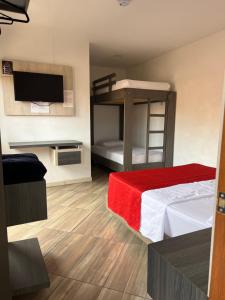 a bedroom with a bunk bed and a television at Hotel La Bastida in Marinilla