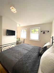 a bedroom with a bed and a flat screen tv at Pastelani in Buckow +33 photos