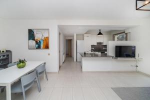 a living room with white walls and a white floor at Central Luxurious 2 bedroom flat in Strovolos