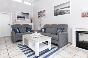 ベンサージールにあるFerienhaus Luv und Leeの2つのソファと暖炉のあるリビングルーム