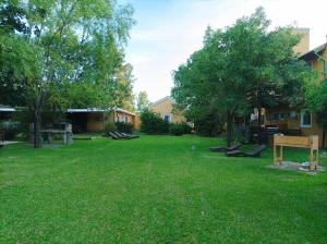 a yard with a sign in the grass at Complejo Azahares in Gualeguaychú +3 photos