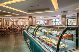 a buffet line in a restaurant with tables at PALEMON Resort& Spa in Manavgat