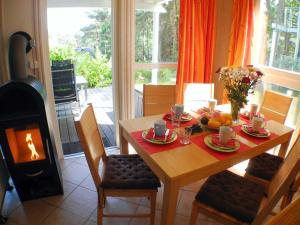 a dining room table with plates of food and a stove at Ferienhaus Sonnenblume in Baabe in Baabe