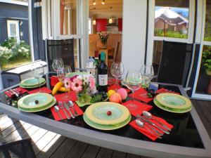 a table with plates and wine glasses on it at Ferienhaus Sonnenblume in Baabe in Baabe