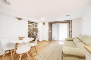 a living room with a couch and a table at Casa de Lamalonga T1 in Campos