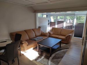 a living room with a couch and a table at Gästehaus Harzklause 7 in Sieber