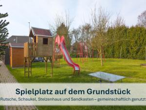 a playground with a slide in a park at Stedesdorf, Ferienhaus 'Seehund' in Stedesdorf
