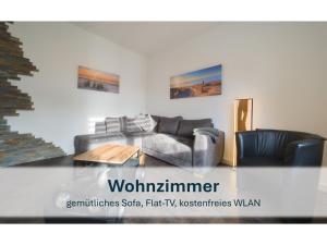 a living room with two couches and a table at Stedesdorf, Ferienhaus 'Seehund' in Stedesdorf