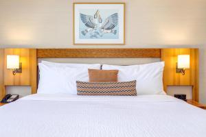 a bed in a hotel room with two pillows at Listel Whistler, a Coast Hotel in Whistler