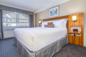 a hotel room with a large bed and a window at Listel Whistler, a Coast Hotel in Whistler