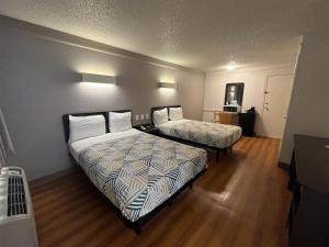 a hotel room with two beds in a room at Studio 6 Suites Euless, TX – DFW West in Euless