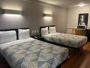 a hotel room with two beds in a room at Studio 6 Suites Euless, TX – DFW West in Euless