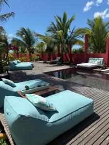 a swimming pool with lounge chairs and a resort at BEACH HOUSE Tatajuba in Camocim