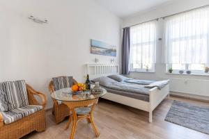 a bedroom with a bed and a table and a couch at Villa Seiler Fewo 6 in Binz