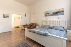 a bedroom with a bed and a desk and a table at Villa Seiler Fewo 6 in Binz +5 photos
