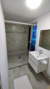 a white bathroom with a sink and a shower at Royal in Crisan