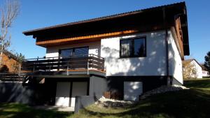 a house on top of a grassy hill at Ferienhaus Gamssteige im Feriendorf Reichenbach G14 in Nesselwang