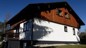 a house with a wooden roof on top of it at Ferienhaus Gamssteige im Feriendorf Reichenbach G14 in Nesselwang
